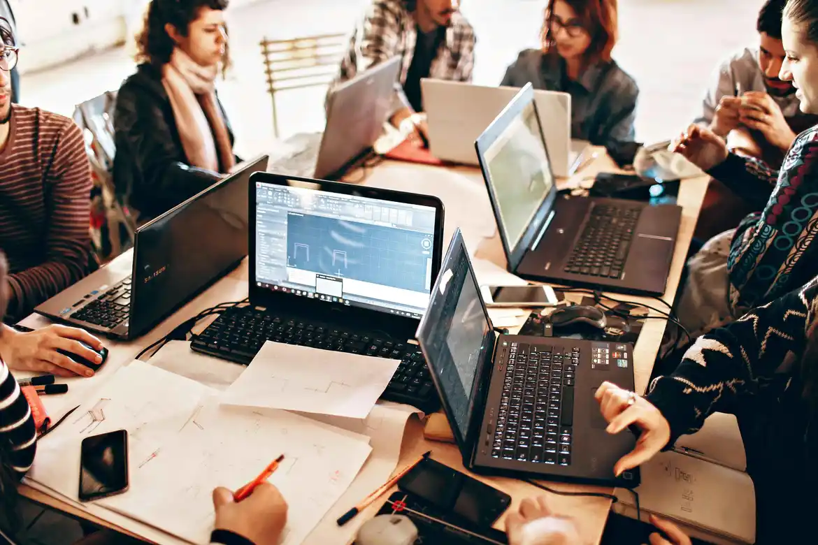 Students attending an IT bootcamp for career change, learning coding and technical skills
