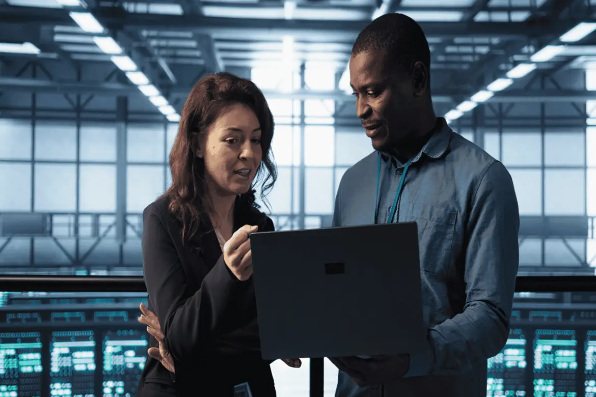 Beginner IT support technician assisting users with computer issues in an office environment